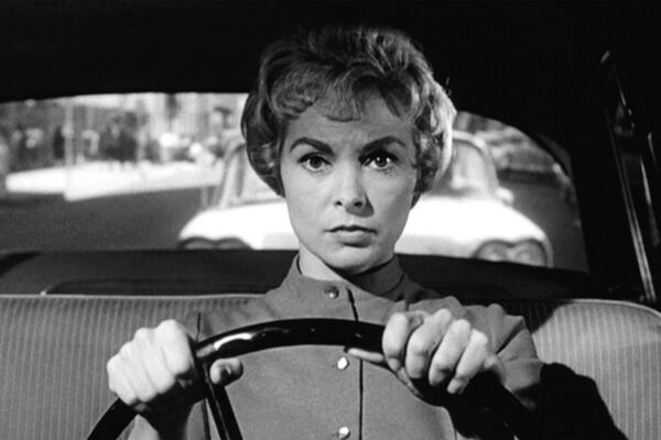 A woman drives a car in black and white photo A woman drives a car in black and white photo