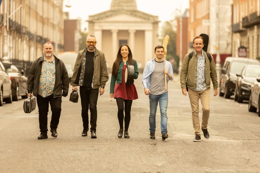5 musicians walking down the road  