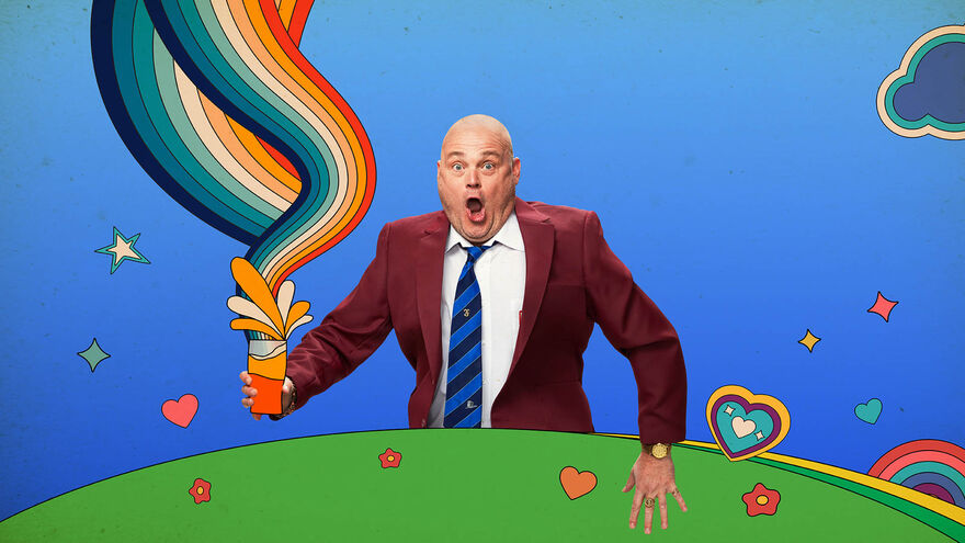 Al Murray behind a cartoon hill with colourful swirls coming out of a glass