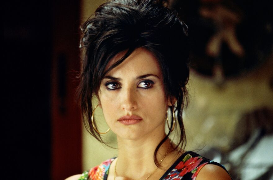 Close up of Penélope Cruz in a flowery dress looking to the right