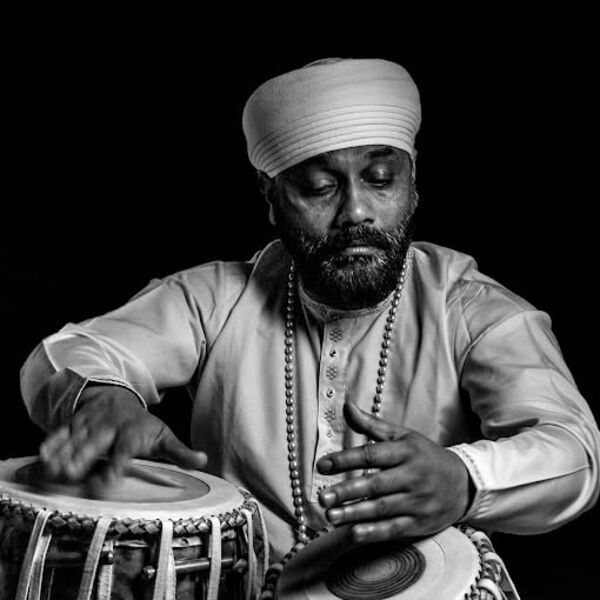 Black and white image of Sukhvinder Singh Pinky playing a jori 