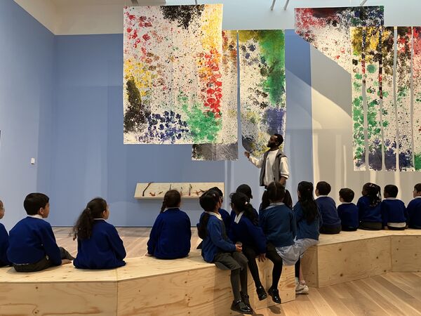 School children in Mead Gallery looking at the artwork they have created.