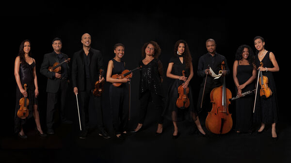 The 9 members of the Chineke! Ensemble holding their instruments