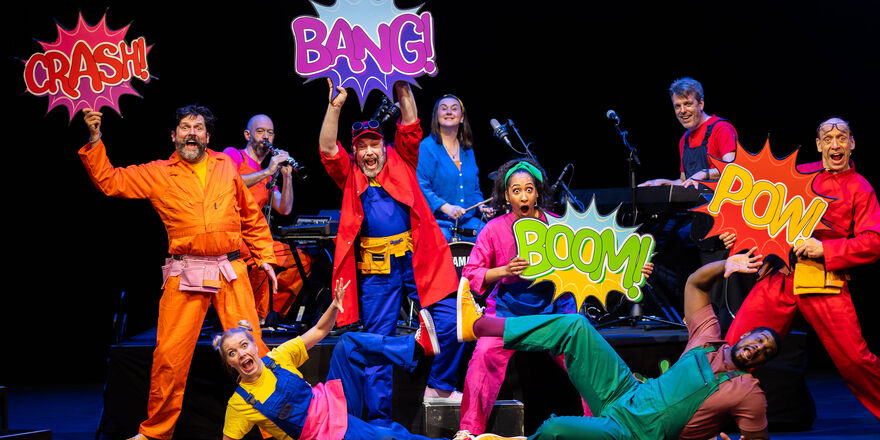 A group of people are playing instruments or holding signs 