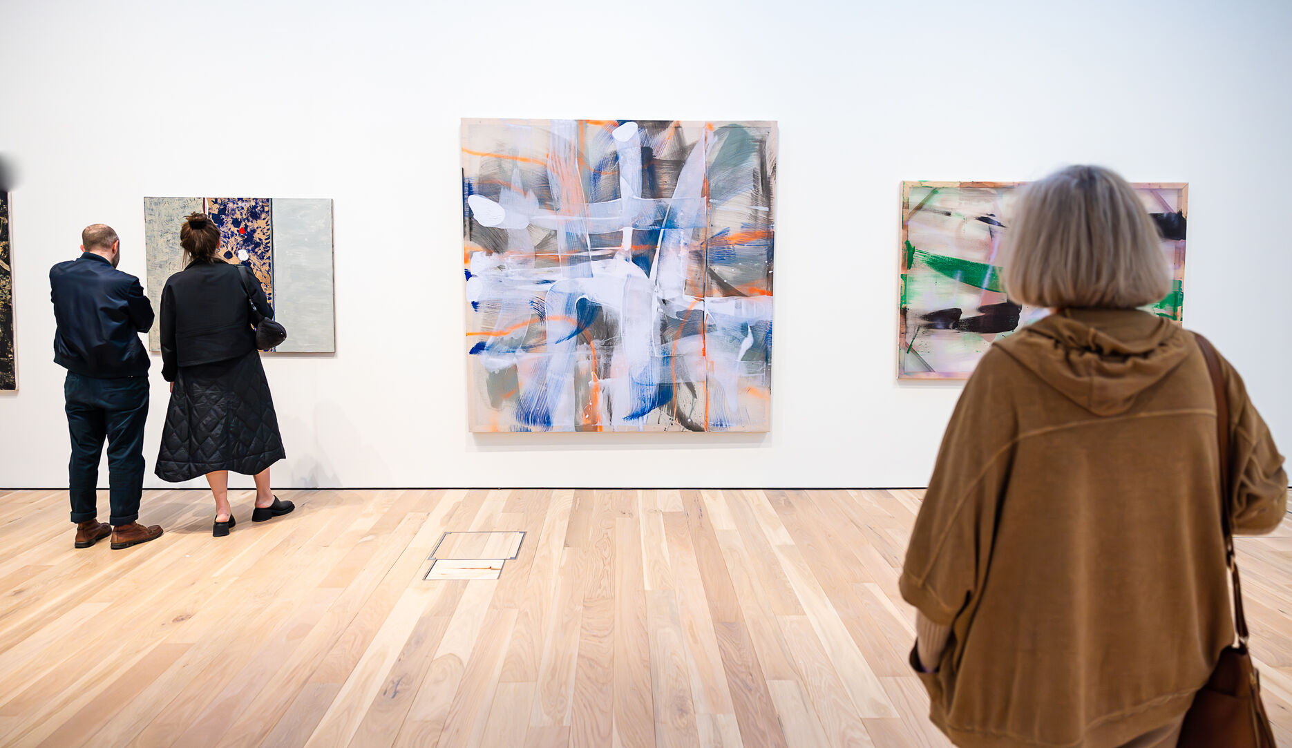 People looking at artwork in the Mead Gallery 