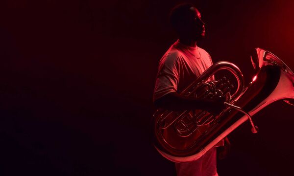 A man holding a tuba