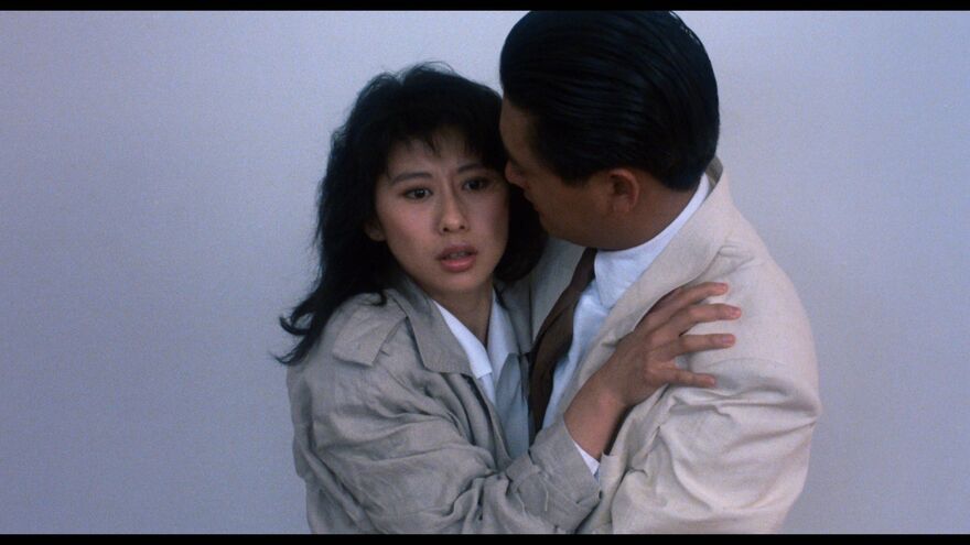 A woman holds onto a man tightly. 