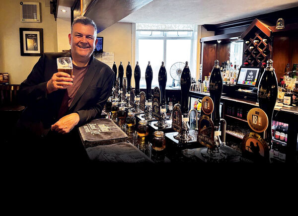 Phil Mealey leaning on a pub bar