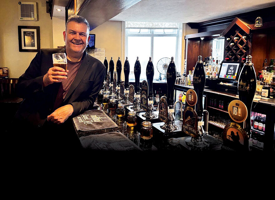 Phil Mealey leaning on a pub bar