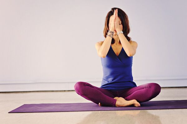 A woman in a yoga position on the floor