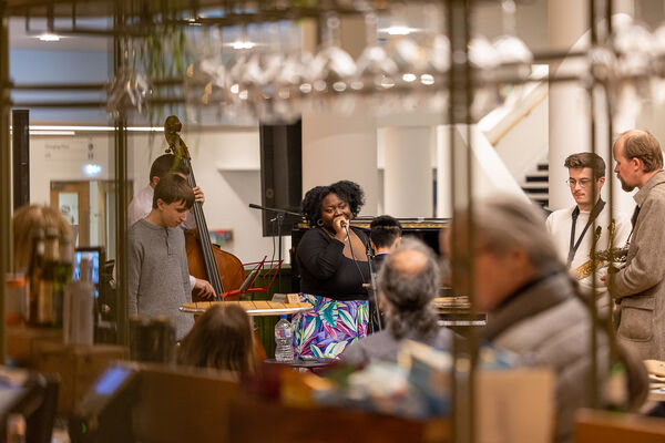 Musicians Benjamin Winstanley (trumpet), Mark Trounson (bass), Tani Fakile (singer), Keenan Ngo (pianist) playing in Benugo for Jazz Fridays Musicians Benjamin Winstanley (trumpet), Mark Trounson (bass), Tani Fakile (singer), Keenan Ngo (pianist) playing in Benugo for Jazz Fridays
