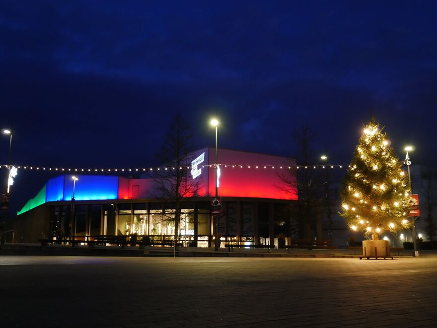 Warwick Arts Centre at night with lit up Christmas tree
