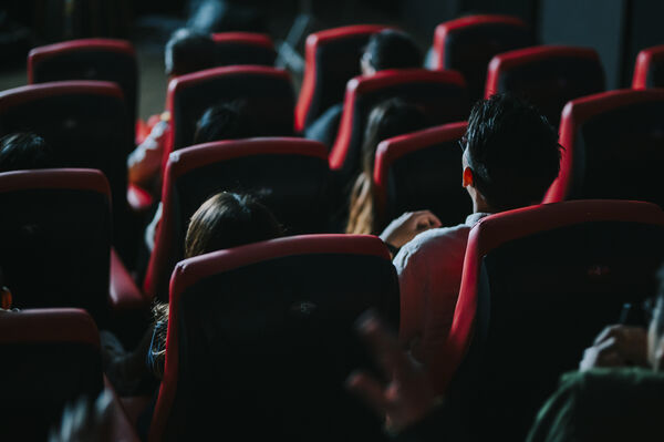 Customers in seats facing a screen