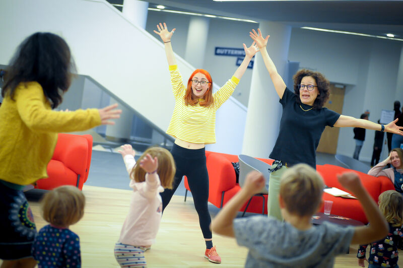 Two instructors leading a dance workshop for children