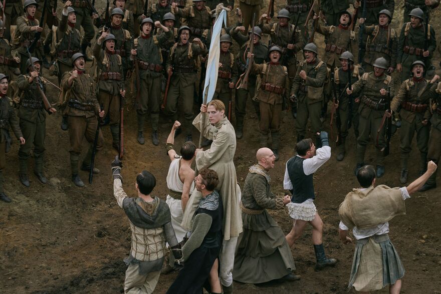 A man holds a white flag surrounded by soldiers. 