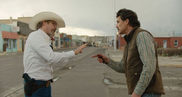 Two men confront one another in a small town street. 