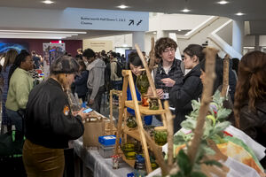 Group of people looking at a market stall with plants on