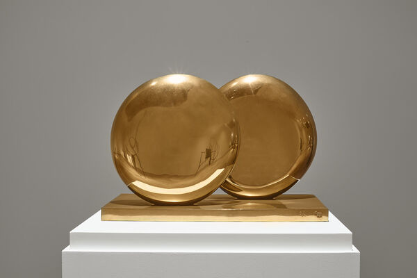 Sculpture by Barbara Hepworth of two gold discs, one overlapping the other
