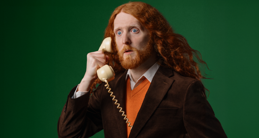 Alasdair Beckett King holding a telephone 