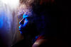 Close up of Macy Gray looking out a steamy window with a blue light on her face