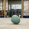 Sculpture of a breadfruit in front of Warwick Arts Centre entrance