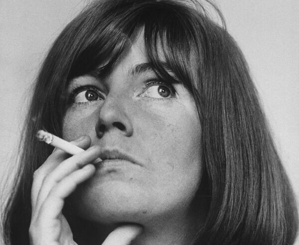 A black and white photograph of Edna O’Brien smoking a cigarette. 