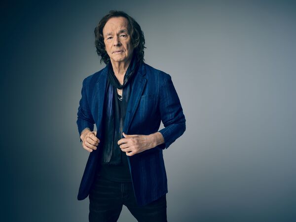 Colin Blunstone in a blue suit jacket and a thin black tie