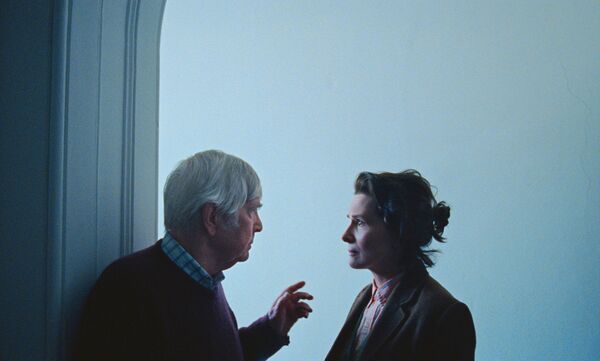 A man and woman speak closely together. A man and woman speak closely together.