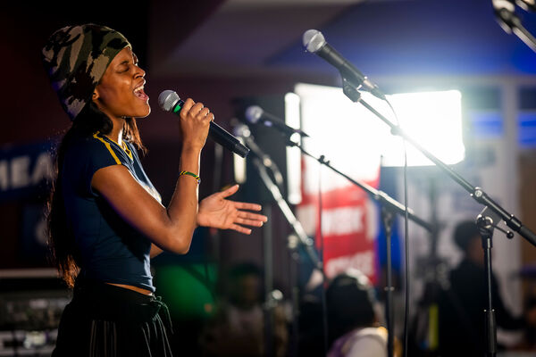 A woman singing into a mircrophone