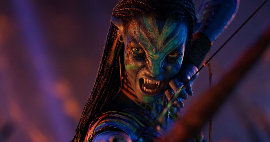 A member of the Na'vi tribe (blue humanoids) aims with a bow and arrow.