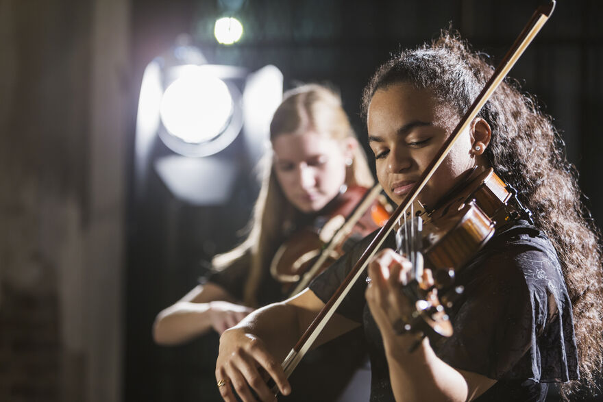Young people playing violins