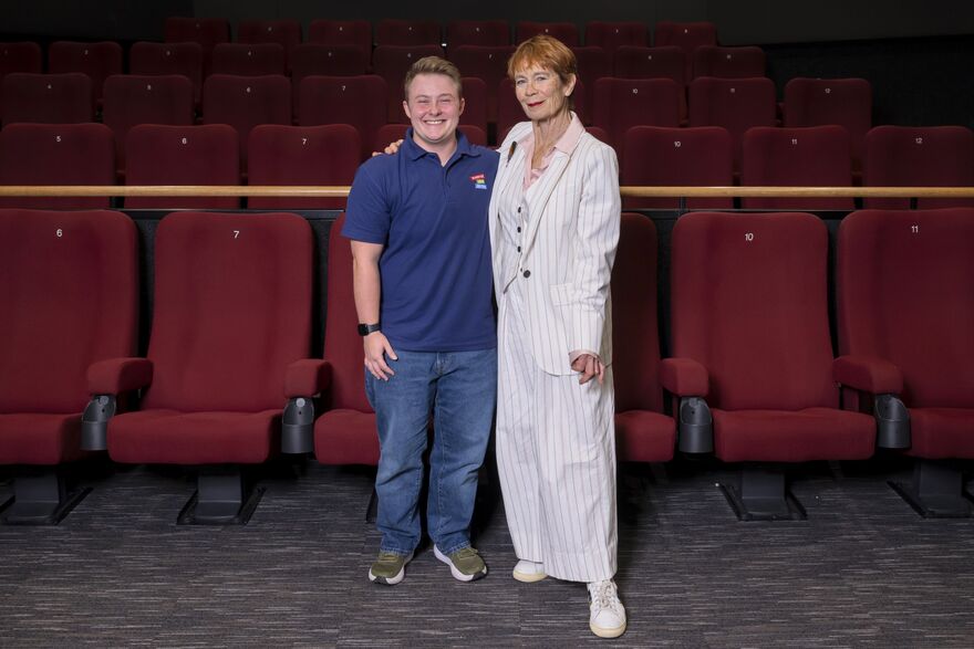 Celiia Imrie and a WAC steward stood in fornt of cinema seats