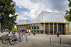 A group of people walking outside the new Arts Centre
