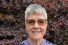 A portrait of Anne Lakey smiling smiling warmly.