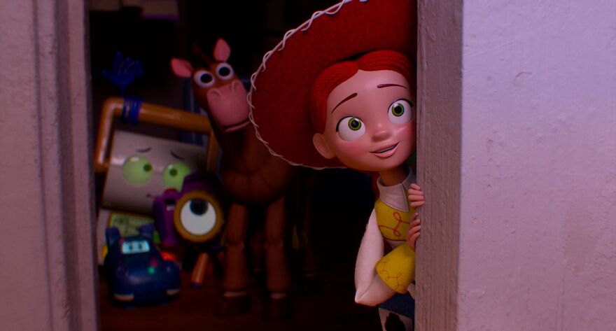 Jessie the cowgirl peeks out of a wardrobe with a small smile. Other toys can be seen in the background. 
