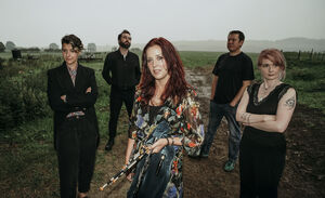 Kathryn Tickell & The Darkening stood in a foggy field 