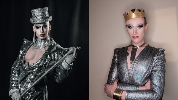 Two drag performers in silver outfits, one in a bedazzled top hat and the other with a gold crown.