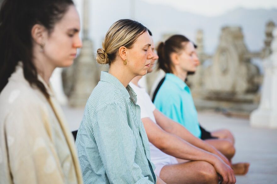 Women sat on the floor meditating