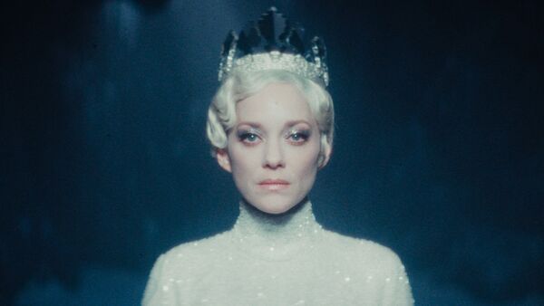 A woman in all white wearing a crown. A woman in all white wearing a crown.