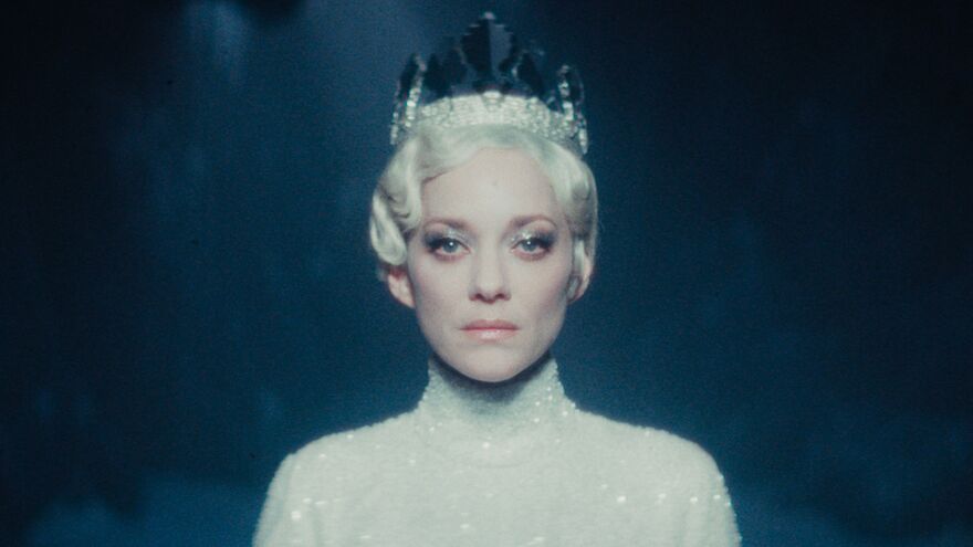 A woman in all white wearing a crown. 