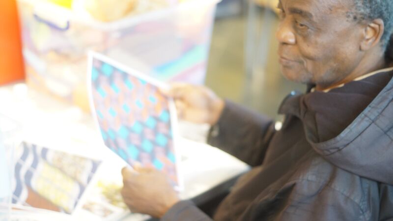 Man holding a photograph in his hands.