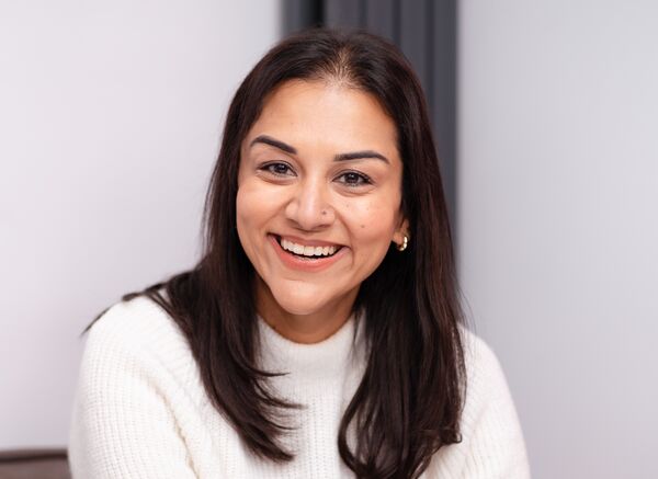 Sukh Kaur Olja in a white jumper, smiling