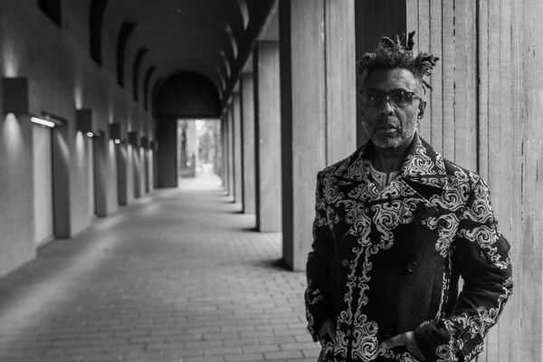 A black and white portrait of the musician Omar.