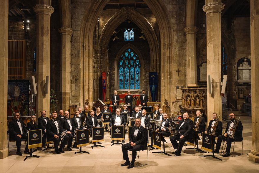 Colliery band sat down with their instruments in a church