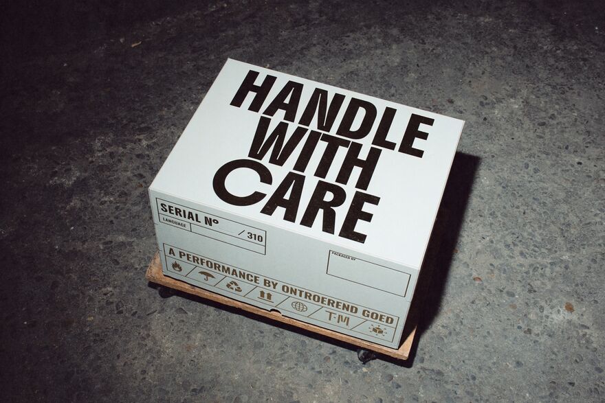 A White box with 'Handle with Care' win block capitals