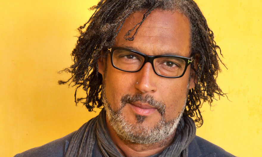 David Olusoga standing in front of a yellow background