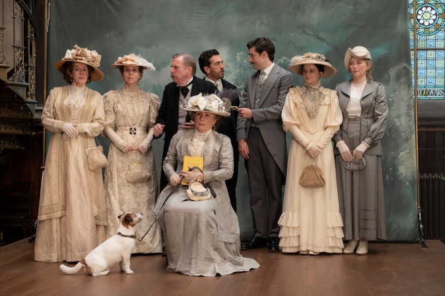 A group of people in period dress pose for a photograph. 