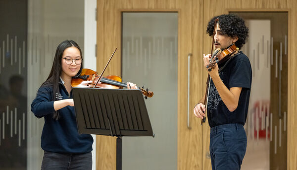 Two students playing violins at Warwick Arts Centre