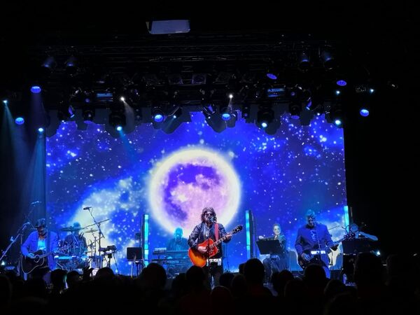Band on Stage with a galaxy background