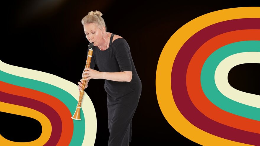 A woman dressed in black playing the clarinet